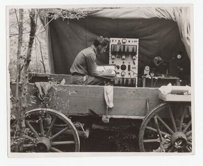 Paul Kellogg recording birds from inside a wagon