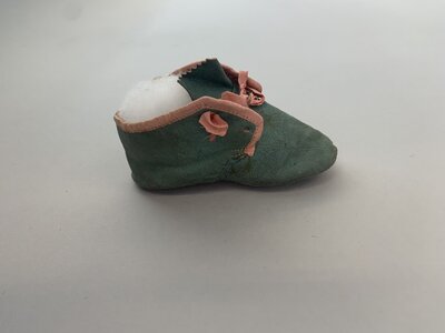 Green leather baby shoe side