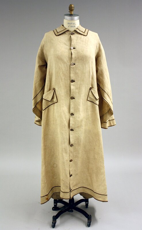 Early twentieth-century caped duster, tan with brown piping (front). 