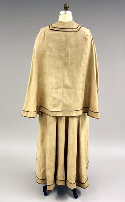 Early twentieth-century caped duster, tan with brown piping (back). 