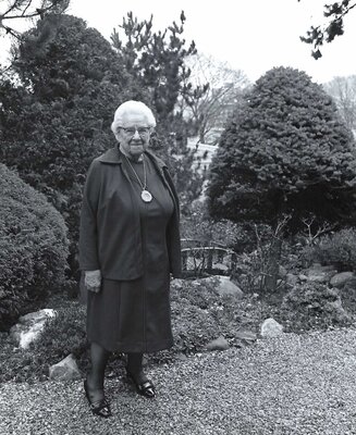 Helen Jewett standing in the Japanese gardens outside of her Little Bungalow Shop in Cortland, NY