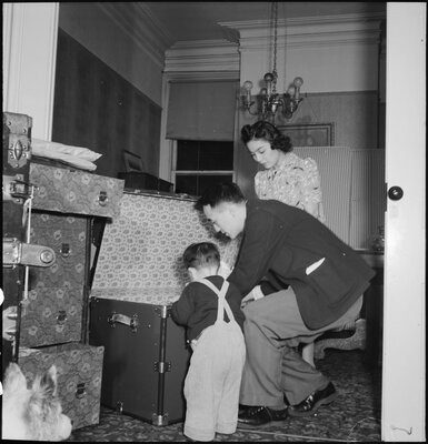 Dave Tatsuno, president of the Japanese American Citizens League of San Francisco, and his family pack for evacuation. 