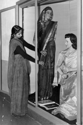 Anjani Mehta, of Bombay, India, arranges an exhibit of native saris in the showcase on the second floor of Martha Van Rensselaer Hall. The date is about 1948.