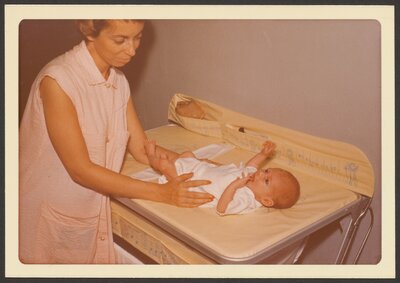 Joyce admires her new baby, Lisa, 1953. 