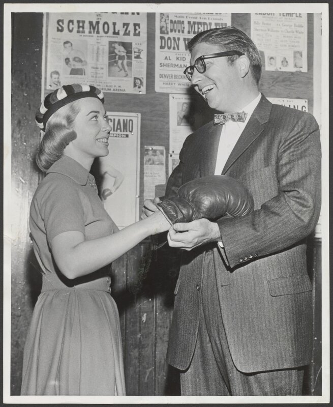 Dr. Brothers publicity photograph, putting on a boxing glove, circa 1955.